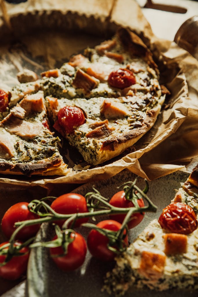 Delicious homemade spinach and cherry tomato quiche, beautifully styled on a rustic table.
